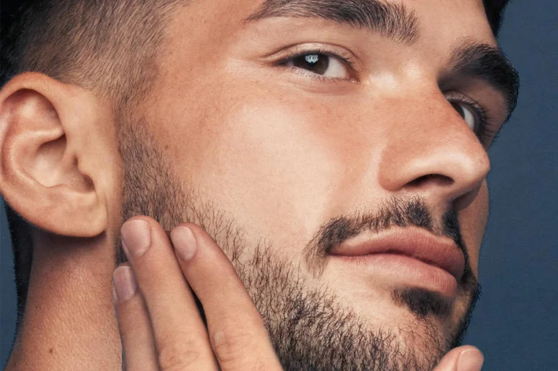 Man touching his beard Man touching his beard