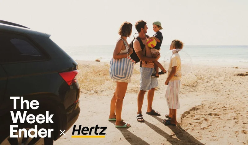 Image description: A family of four stands on a beach near an SUV. The WeekEnder x Hertz