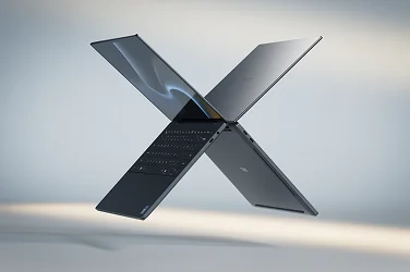 Two Dell XPS laptop computers floating in midair in the shape of the letter “X”.