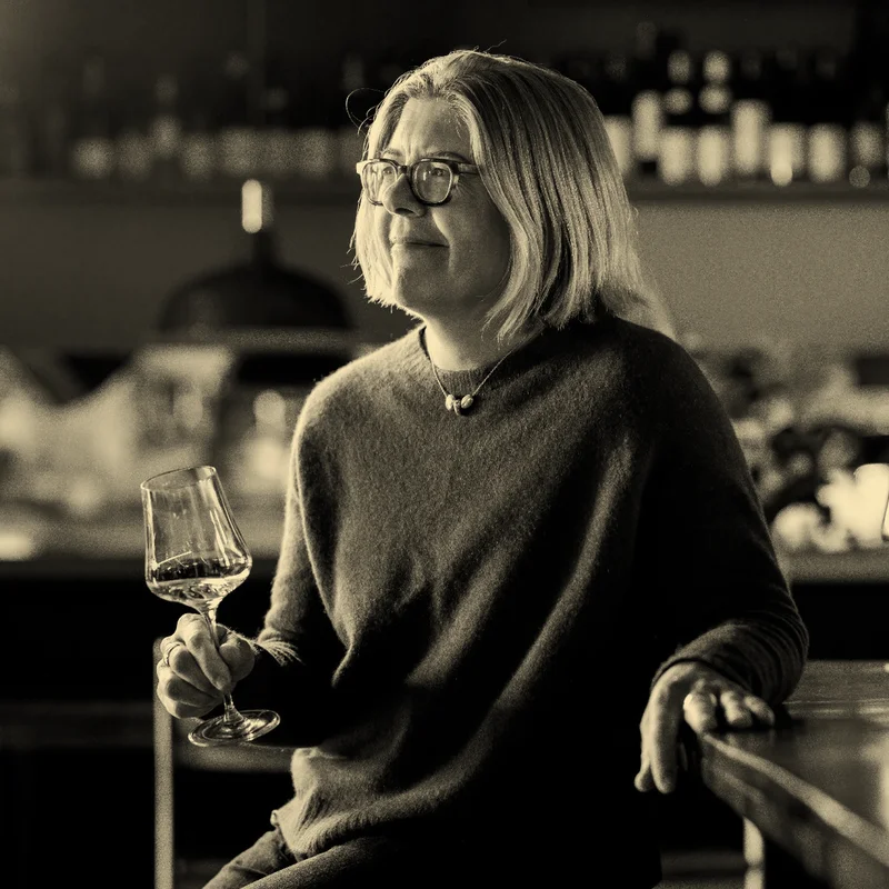 Photo of winemaker Samantha Connew sitting with a glass of wine.
