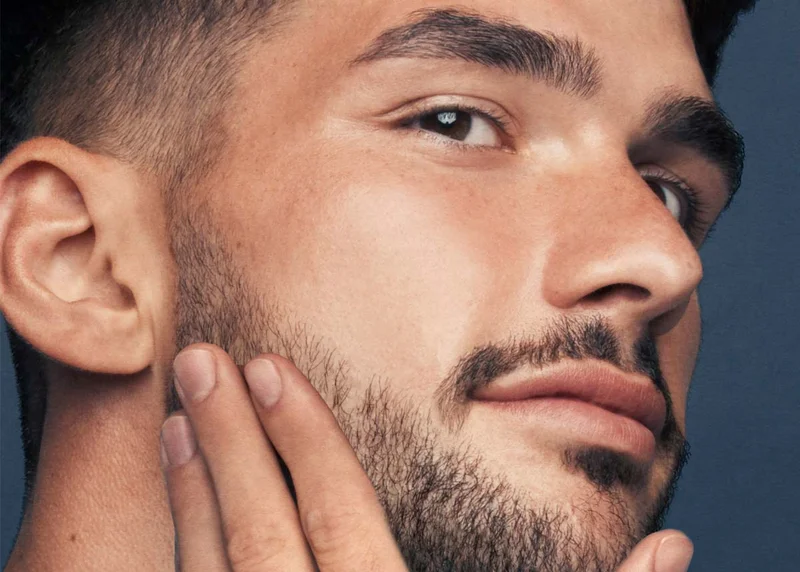 Young man touching his groomed beard