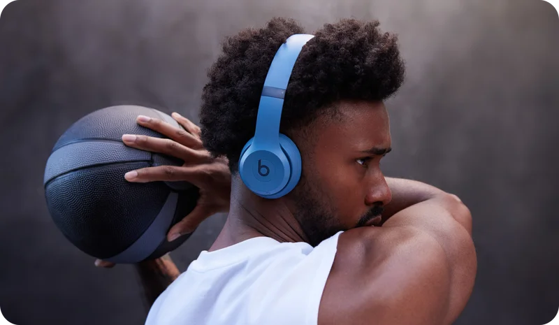 Person wearing Beats Solo 4 in Slate Blue while playing basketball.
