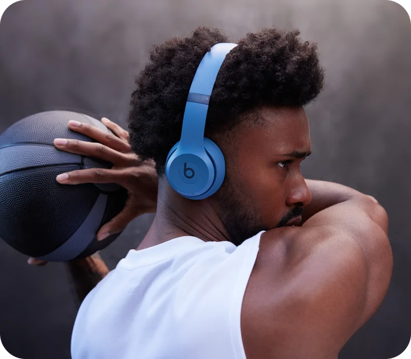 Person wearing Beats Solo 4 in Slate Blue while playing basketball.