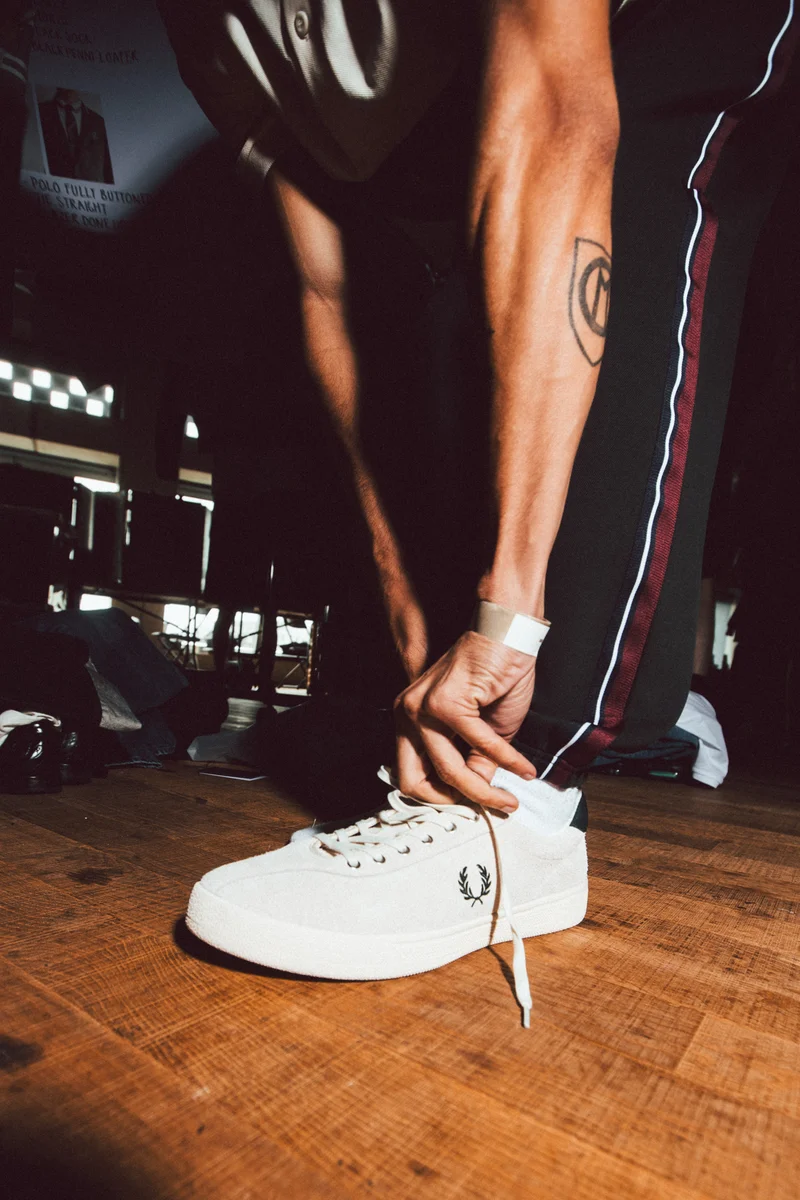 Model wearing a Fred Perry Tennis Shoe