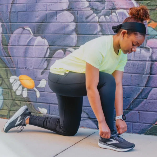 Woman tying Brooks Ghost 16 shoes