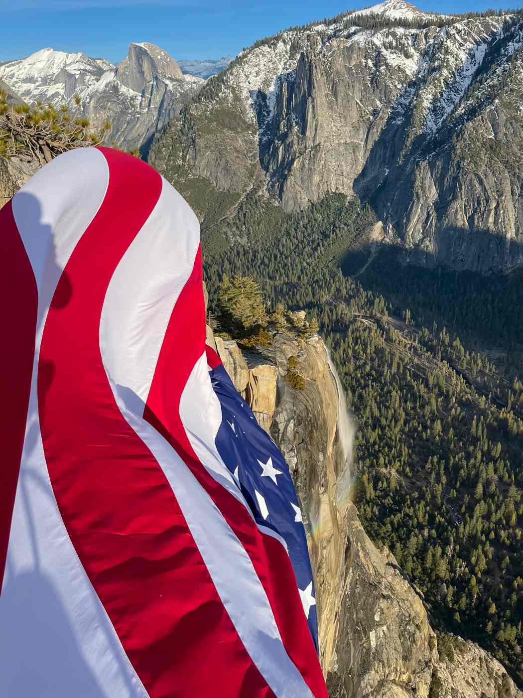 An American flag hangs upside down from the top of El Capitan in Yosemite.