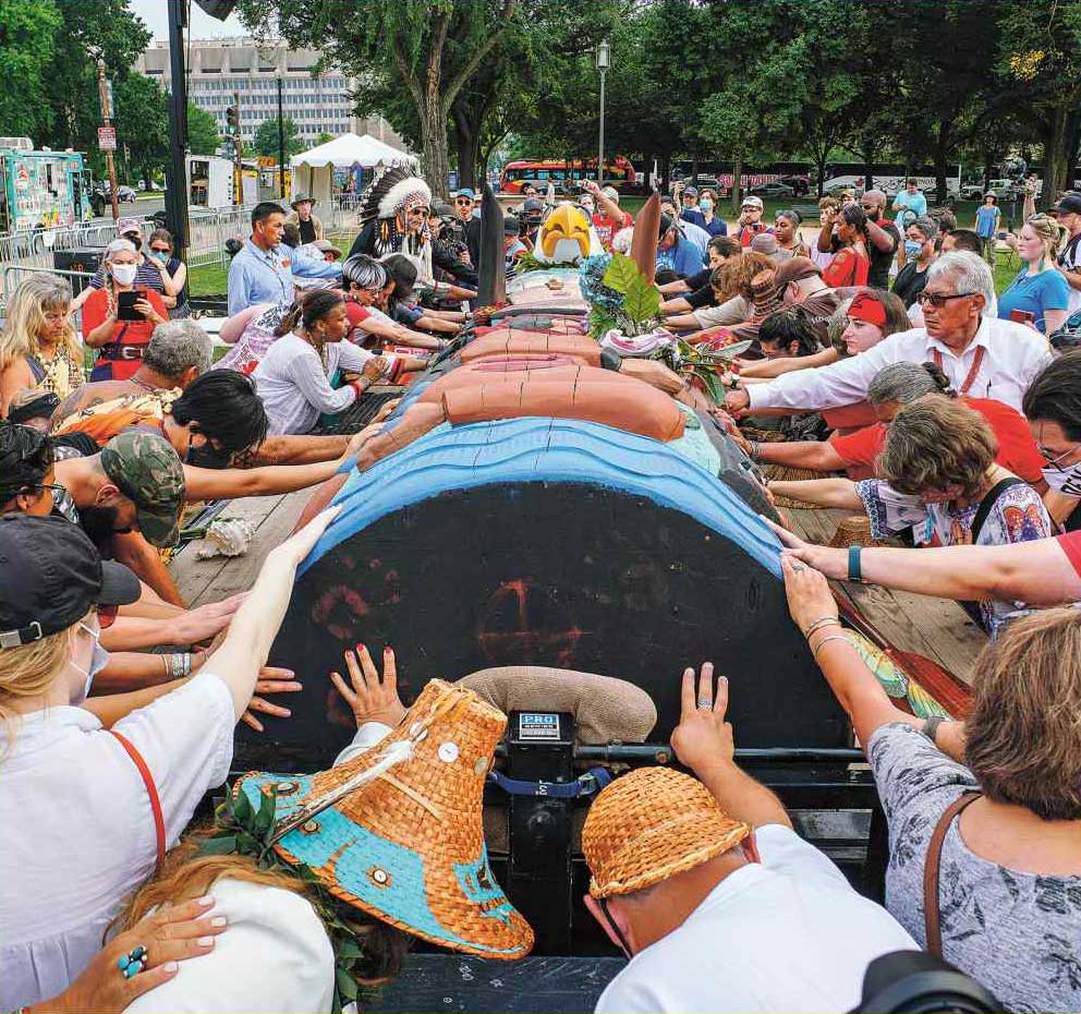 Patagonia Action Works. A group of people delivering a totem pole in Washington, DC.