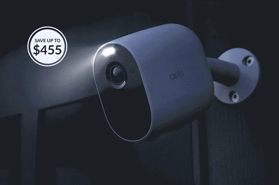 Save up to $455. Arlo Essential Wireless Security Camera at night with the integrated spotlight turned on. Animated image shows nightime shifting to daytime as the spotlight turns off.