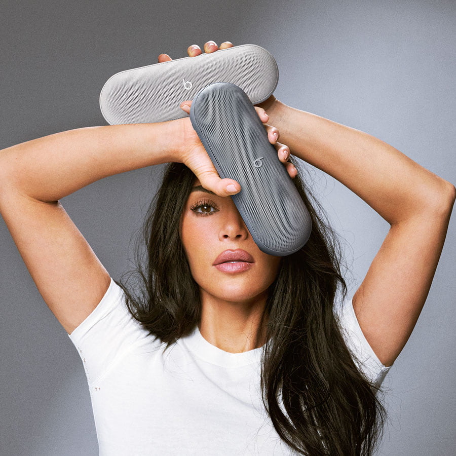 Kim Kardashian holding the limited edition Beats Pill speakers in Light Gray and Dark Gray.