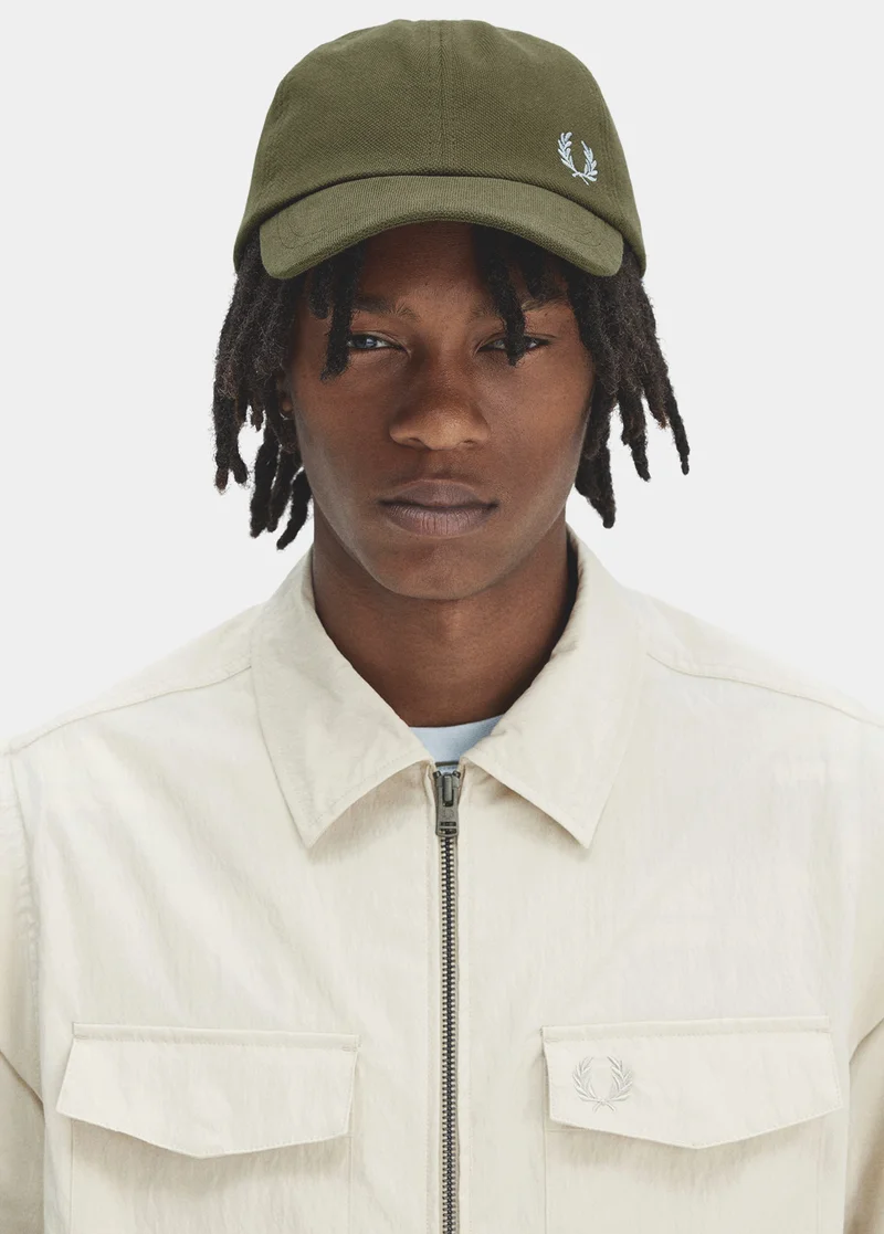 Man wearing Fred Perry bucket hat and jacket