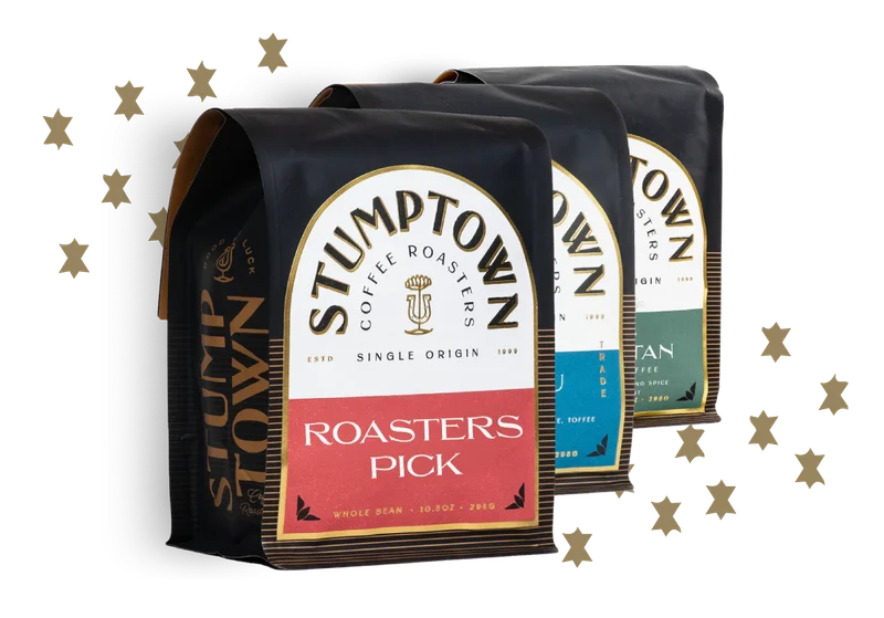 Three Stumptown Roaster’s Pick coffee bags with gold stars on a light background.