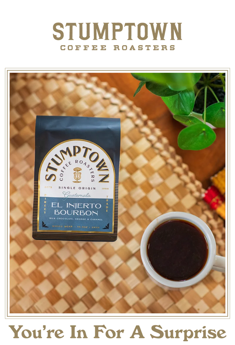 Stumptown Coffee Roasters El Injerto Bourbon whole bean bag from Guatemala sits on a woven tray beside a white cup of black coffee, with a green plant in the background. Headline below reads, “You’re In For A Surprise.”