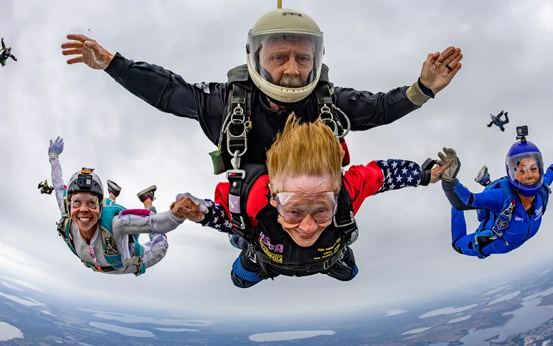 86-year-old Kim Knor completes her 1,000th jump in New Wales, Florida, alongside her two daughters.