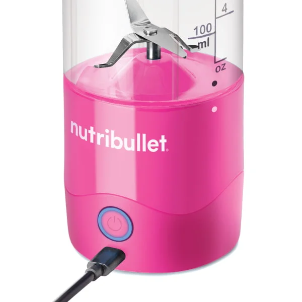 Close-up image of the pink nutribullet Portable Blender base while plugged in for charging.