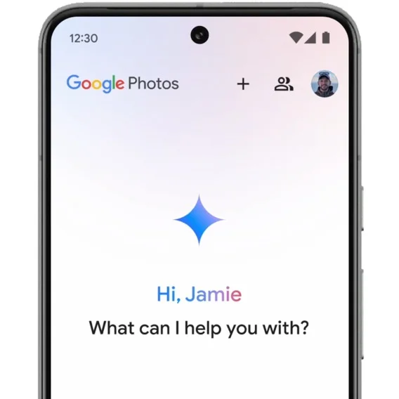 Image of a Pixel phone open to Google Photos with a star icon on the screen and the phrase “Hi Jamie, what can I help you with?” below it.