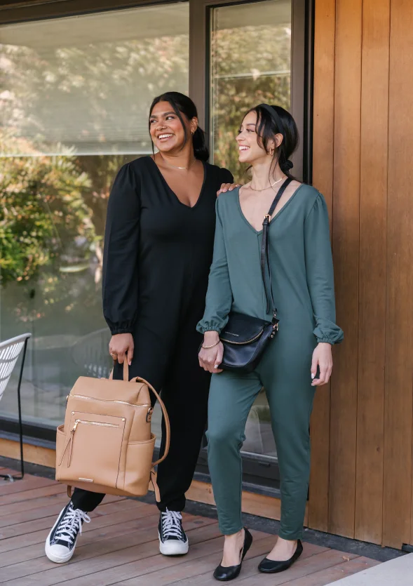 two women wearing black and green frankie romper in front of glass window