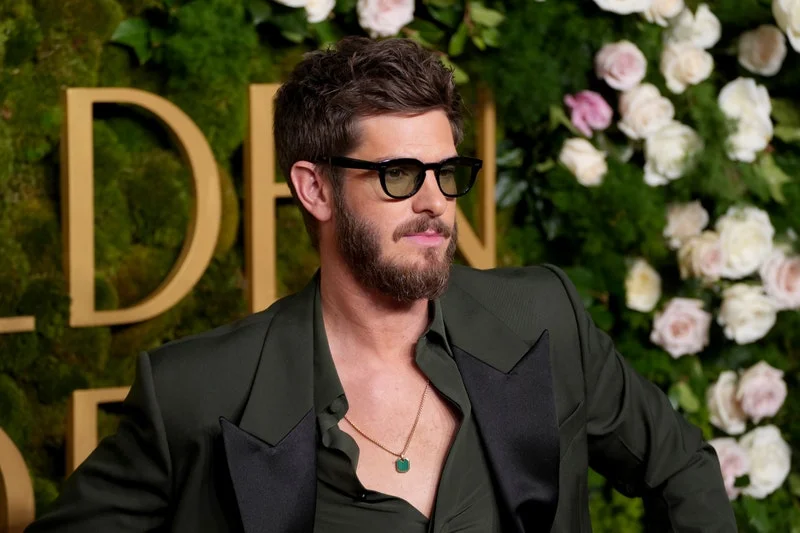 Image may contain: Andrew Garfield, Accessories, Glasses, Jewelry, Necklace, Adult, Person, Pendant, Face, Head, and Blazer