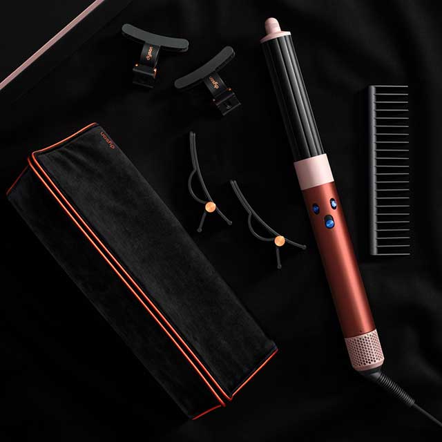 Dyson Airwrap i.d. multi-styler and dryer and accessories in Strawberry bronze and blush pink.