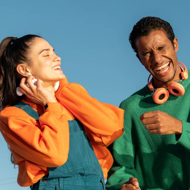 A woman and a man wearing earplugs at a live event.