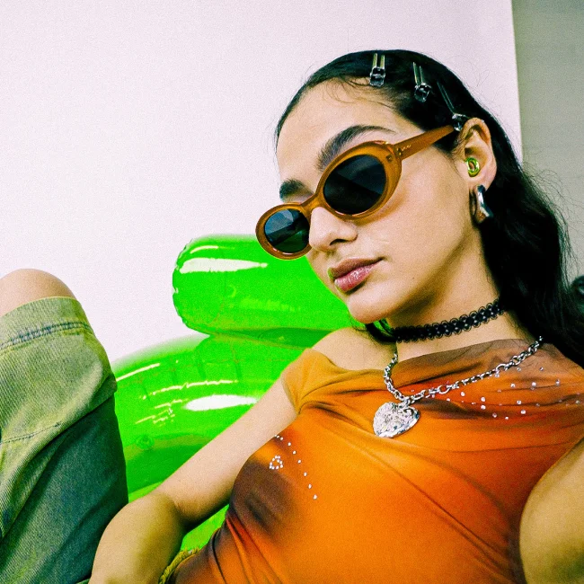 A woman wearing accessories including Kinetic earplugs.