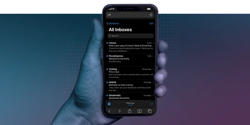 hand holding up a phone in dark mode