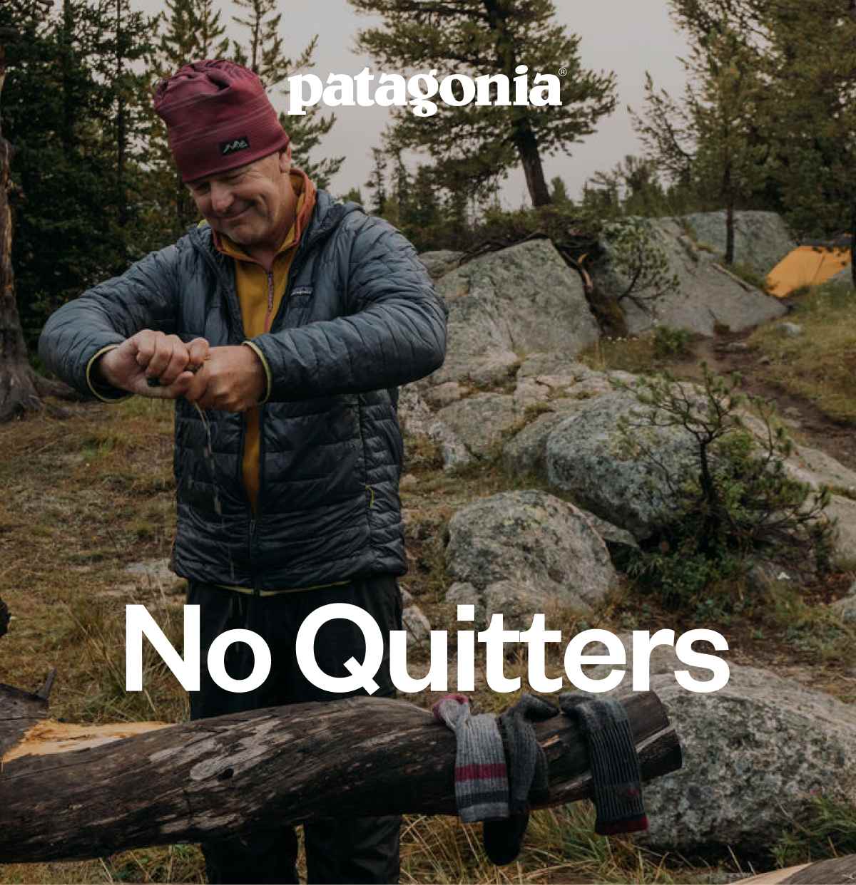 Patagonia. No Quitters. A backpacker wrings water from his socks and puts them on a log to dry out.