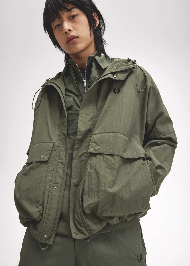 Man wearing a dark green layered outfit