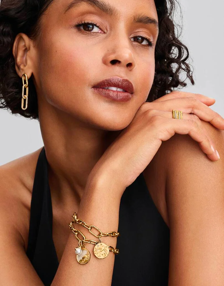 Model wearing bracelets and charms