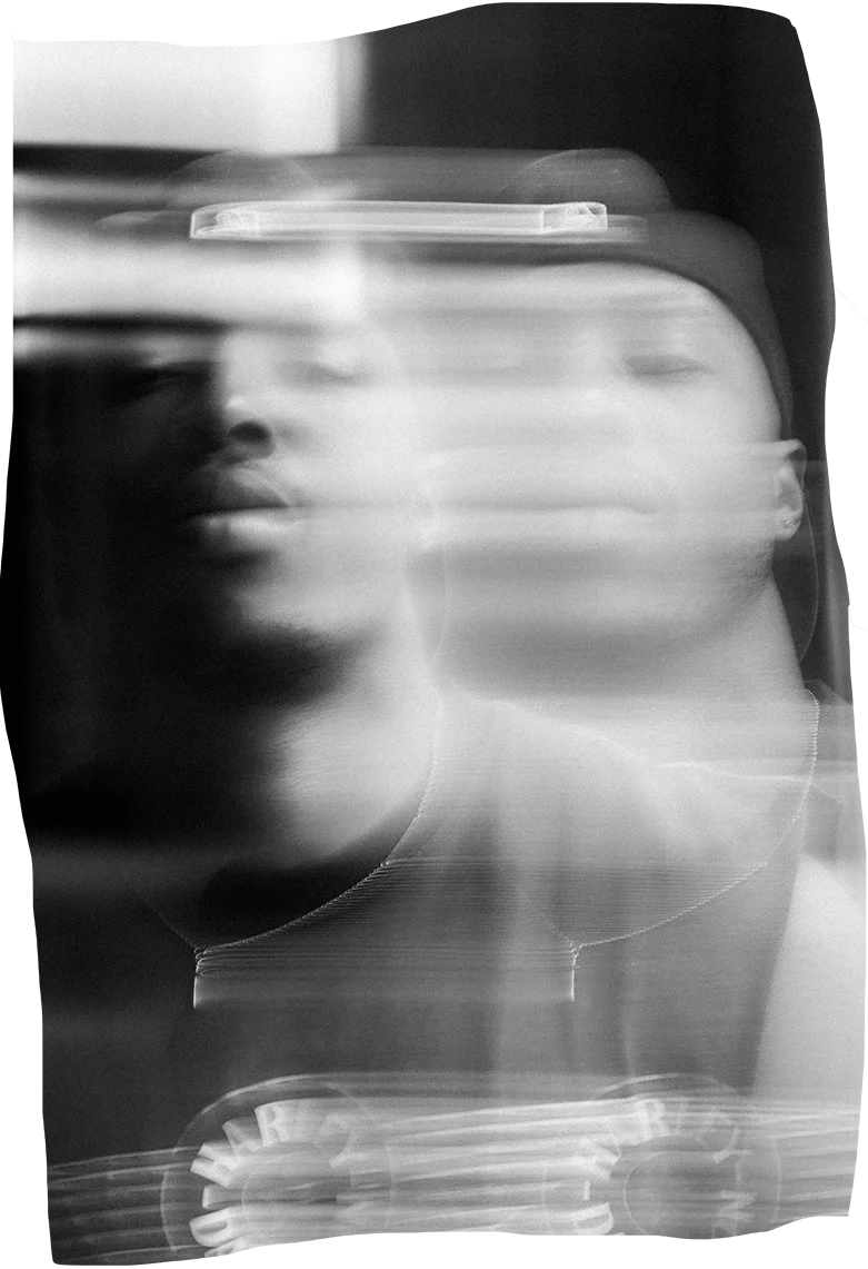 A monochromatic and ethereal portrait of Justen Leroy, with the features slightly blurred, giving an effect of motion or transition.