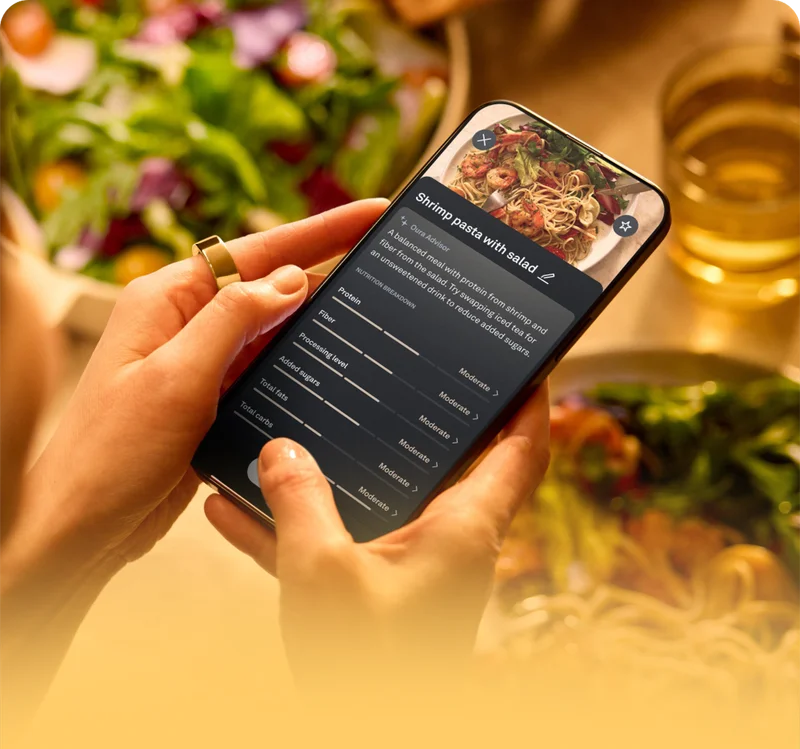 Person wearing Oura Ring taking a picture of their meal in Oura app