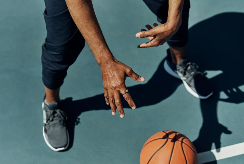 Man playing basketball wearing Oura Ring
