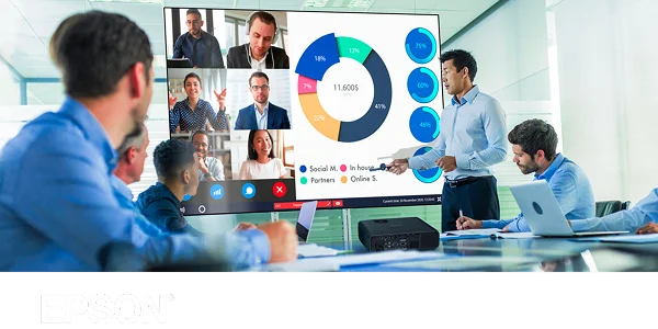 A team of executives watching a bright and colorful presentation on a screen in front of an Epson projector.