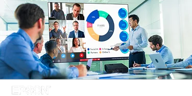 A team of executives watching a bright and colorful presentation on a screen in front of an Epson projector.