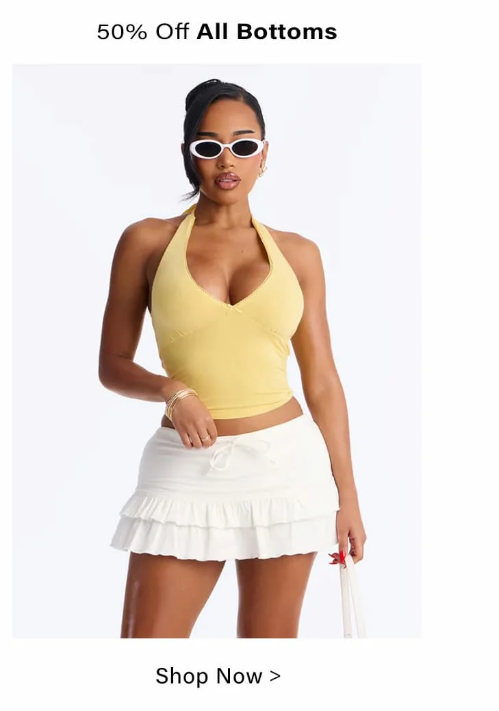 50% Off All Bottoms sale: Model wears trendy white ruffled mini skirt and yellow halter top. Shop women's fashion now!