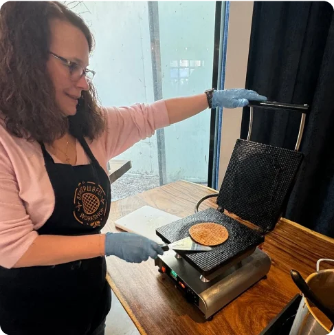 Image Description: A person making a stroopwafel.