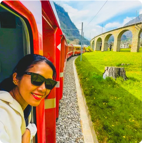 Image Description: A person looking out the window of a train.