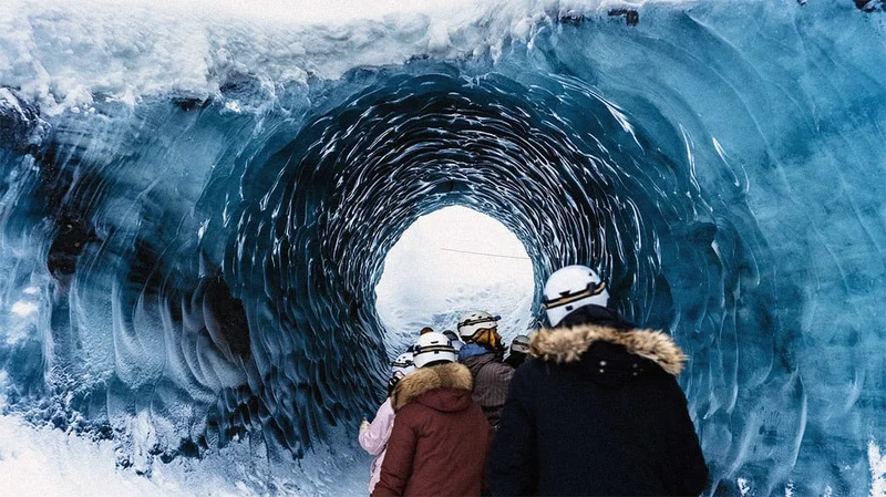 Image description: Tour hiking through an ice cave in Iceland.