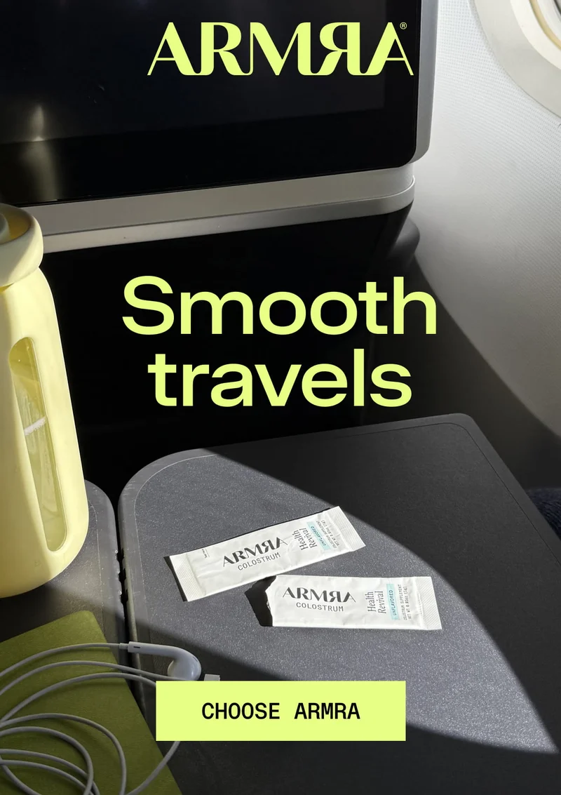 Smooth travels CHOOSE ARMRA - Img shows Two ARMRa travel sticks on airplane tray table with headphones and water bottle in airplane cabin setting.