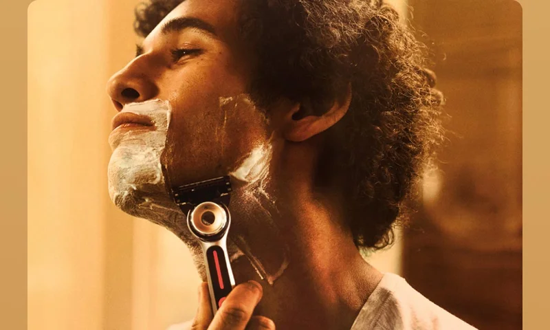 Man shaving his face with GilletteLabs Heated razor