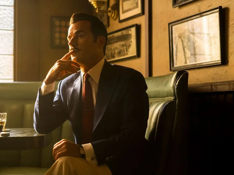 Image may contain: Justin Theroux, Blazer, Clothing, Coat, Jacket, Head, Person, Face, Formal Wear, Suit, Adult, and Couch