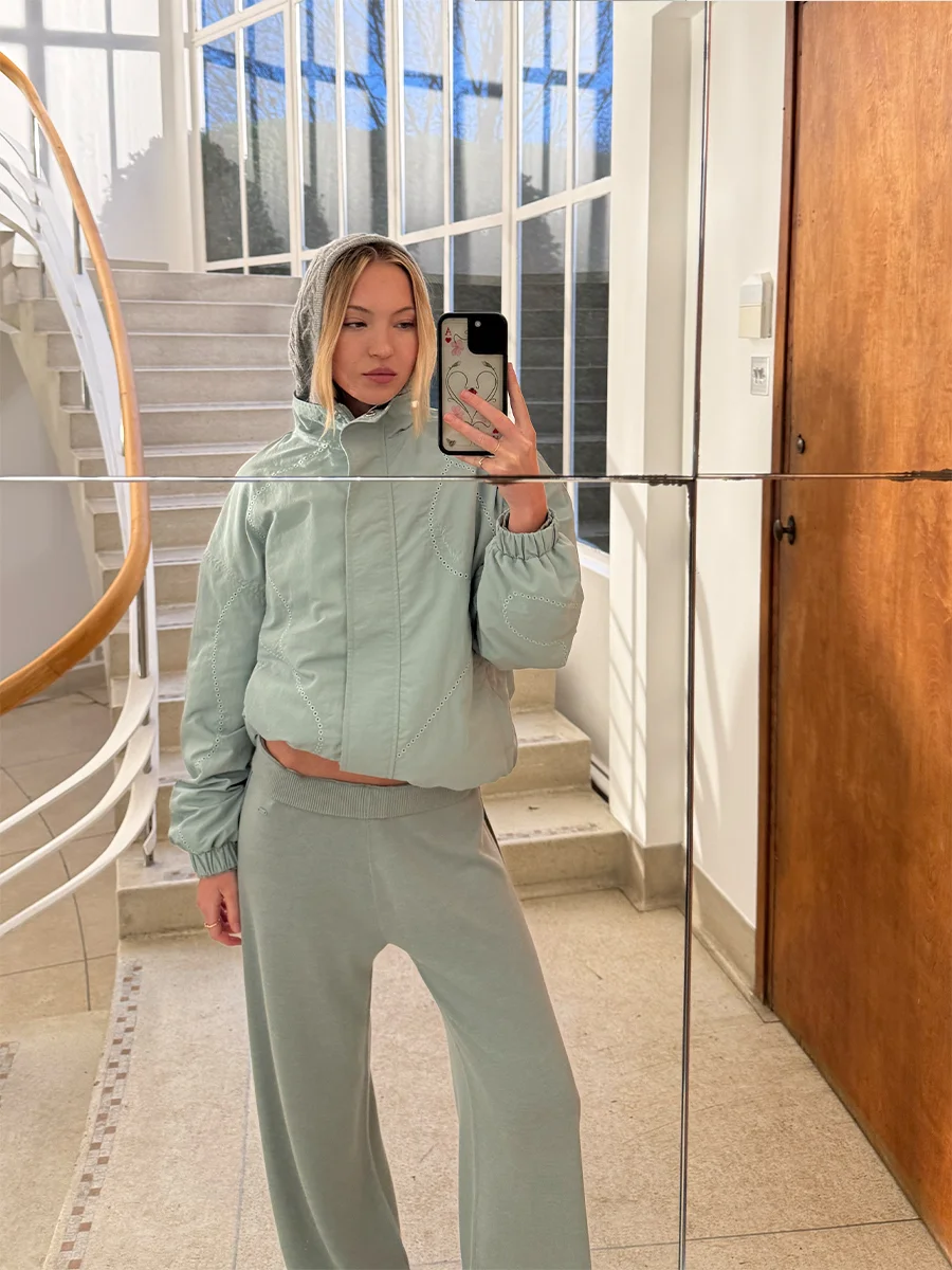 As seen on Lila Moss: Laser Cut Track Jacket + Knit Stripe Straight Leg Trousers