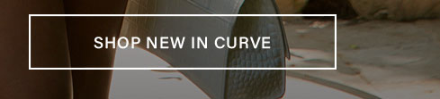 Close-up of a person in new curve clothing, featuring earthy tones against a subtle background, with a 'SHOP NEW IN CURVE' call to action button.