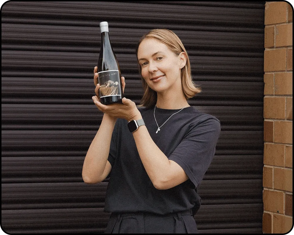 Kirby happily holds up her chosen La Petite Mort Chardonnay.