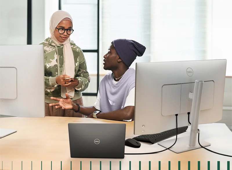 Coworkers discussing with Dell equipment