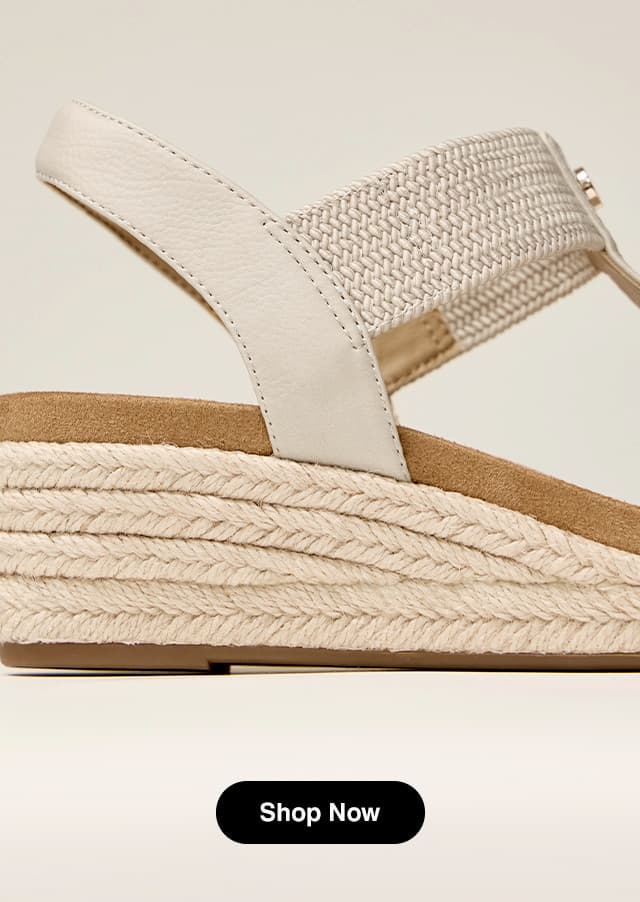 A close-up of the espadrille wedge and slingback strap of the Timina Sandal in Beige.