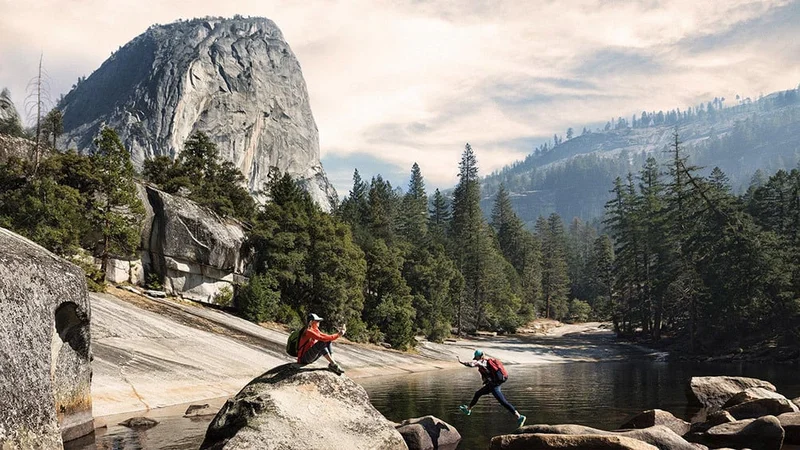 Image description: Two women taking photos at The Emerald Pool above Vernal Falls, in Yosemite National Park