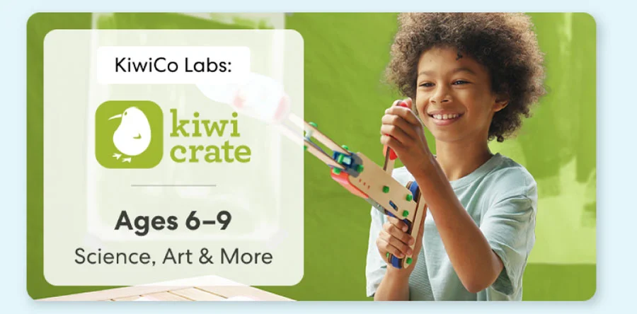 Young girl smiling while working on a science experiment from KiwiCo Labs. Hands-on STEM learning for ages 6–8.