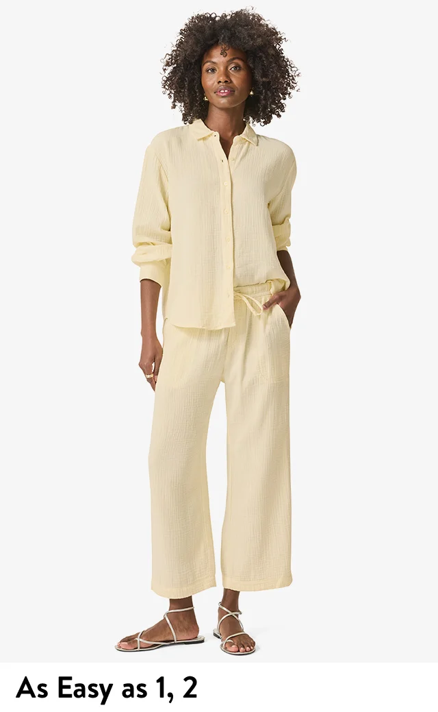 Woman wearing a pale yellow button-up shirt and matching pants.