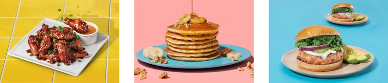 Baked chicken wings on a plate   Stack of pancakes with syrup and fruits   Salmon burger