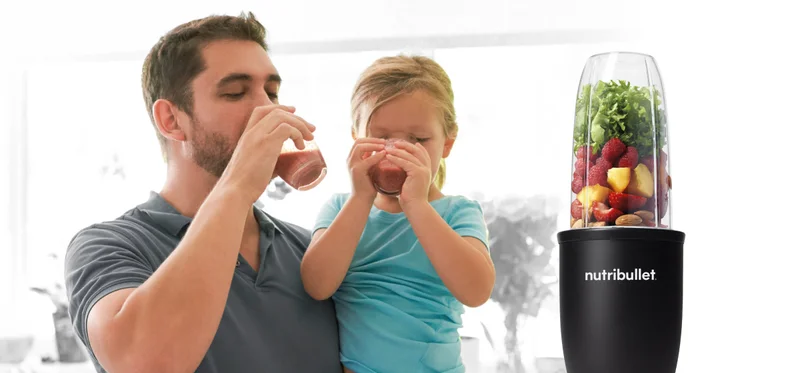 Dad and child drinking a smoothie
